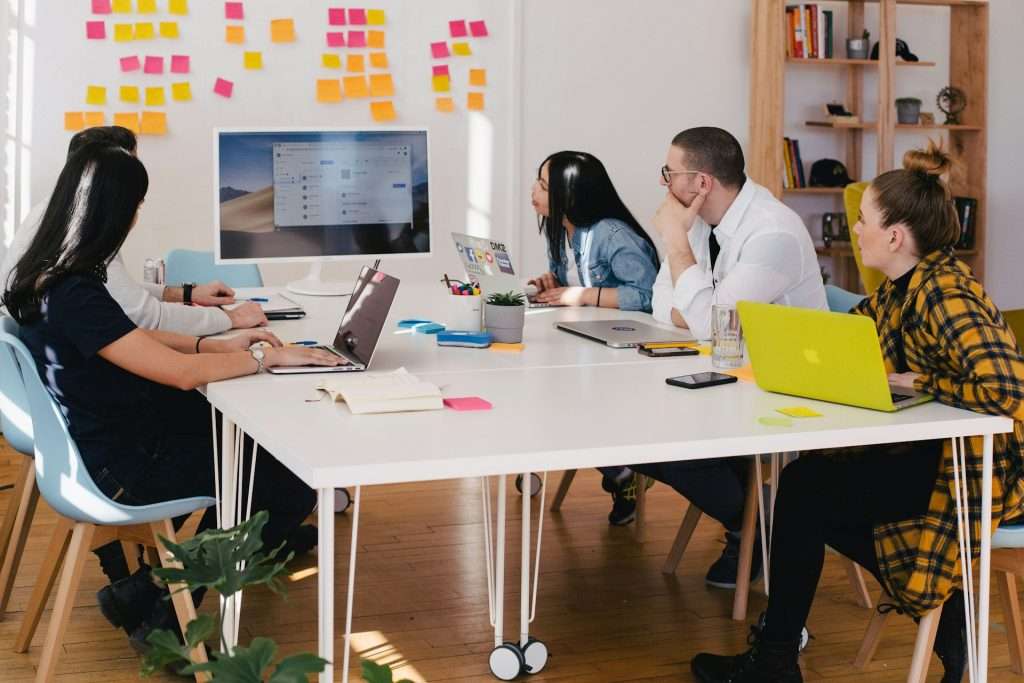 People around a table participating in a virtual workshop or webinar production
